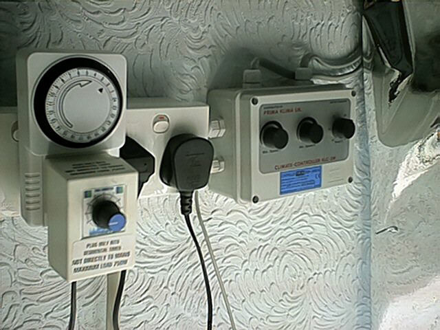 This is how I control both my fans. A temperature sensor switches the fans on when the room becomes too hot. One fan takes hot air out from the top of the room, and one brings cooler, fresh air near the floor of the room. The fans constantly run at a very slow speed, and only come on at full blast when the room is too hot. You can also see the timer that controls the flooding and draining of the system to deliver nutrients to the plants.
