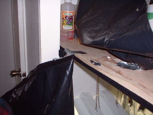Velcro was used to secure the tarp. This provides easy access and prevents light from escaping into the flowering chamber. If you use this method secure the velcro to both the tarp and wood with more than the adhesive on the back of the velcro.